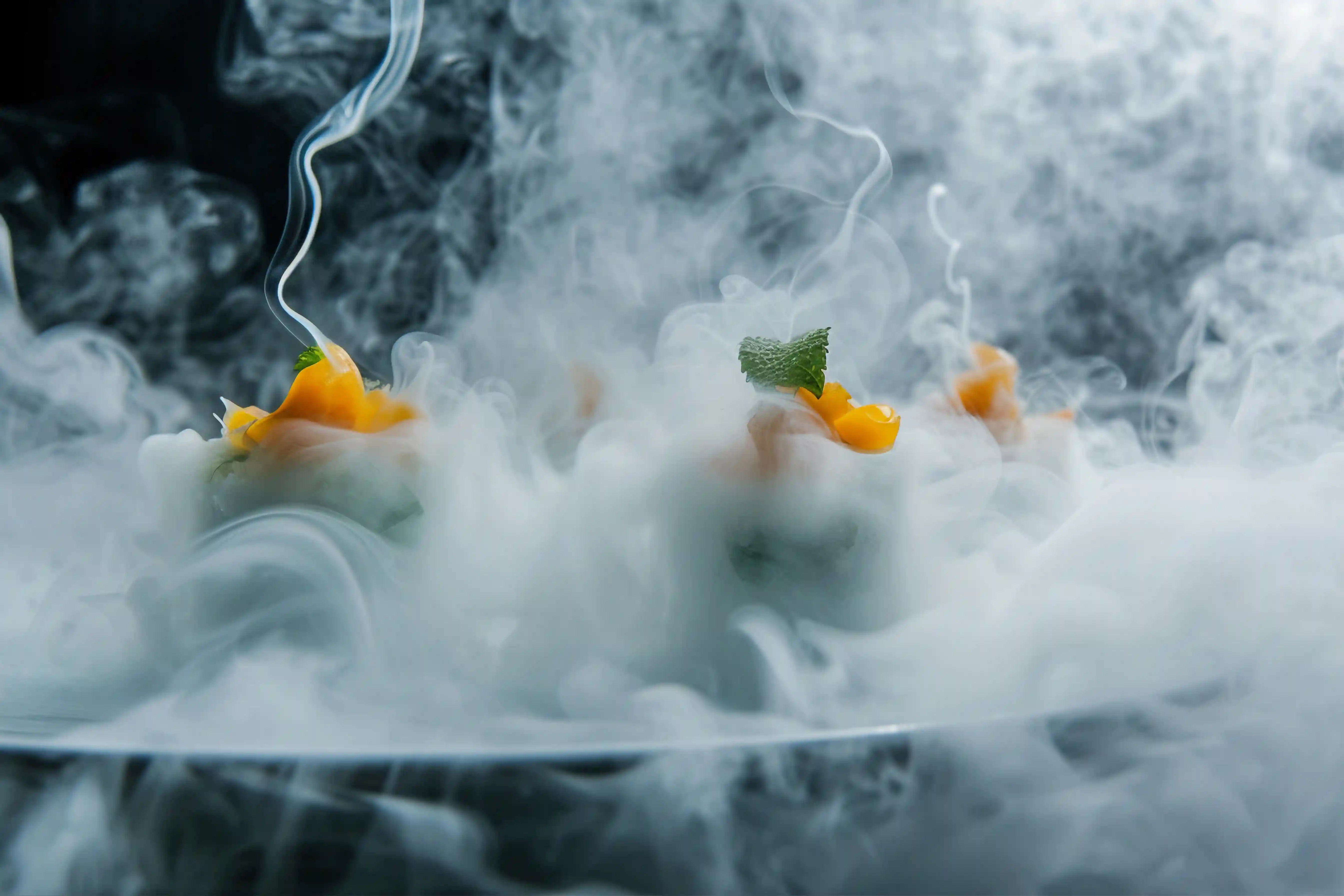 Dry ice creating fog effect for food presentation in restaurant setting